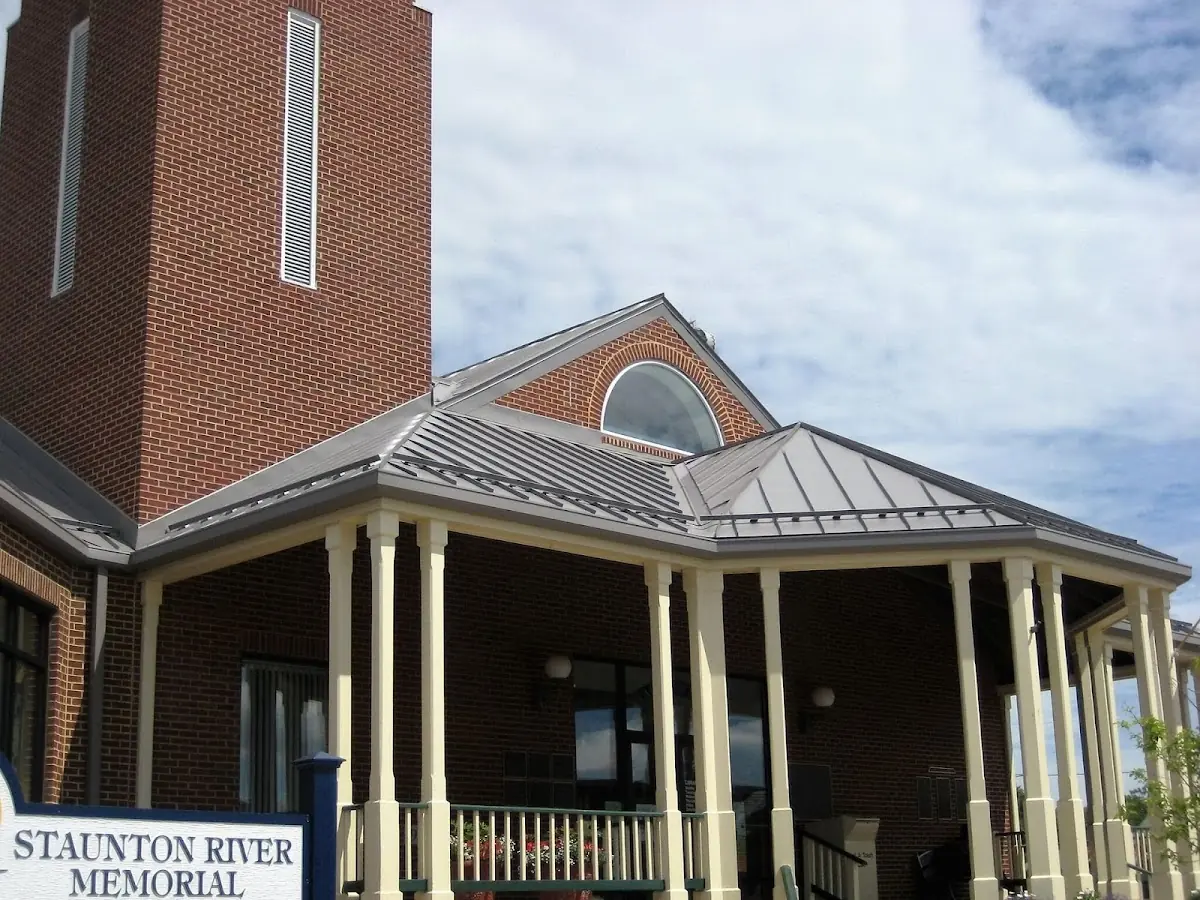Skilled roofing craftsmen working on a residential roof in Little River Academy